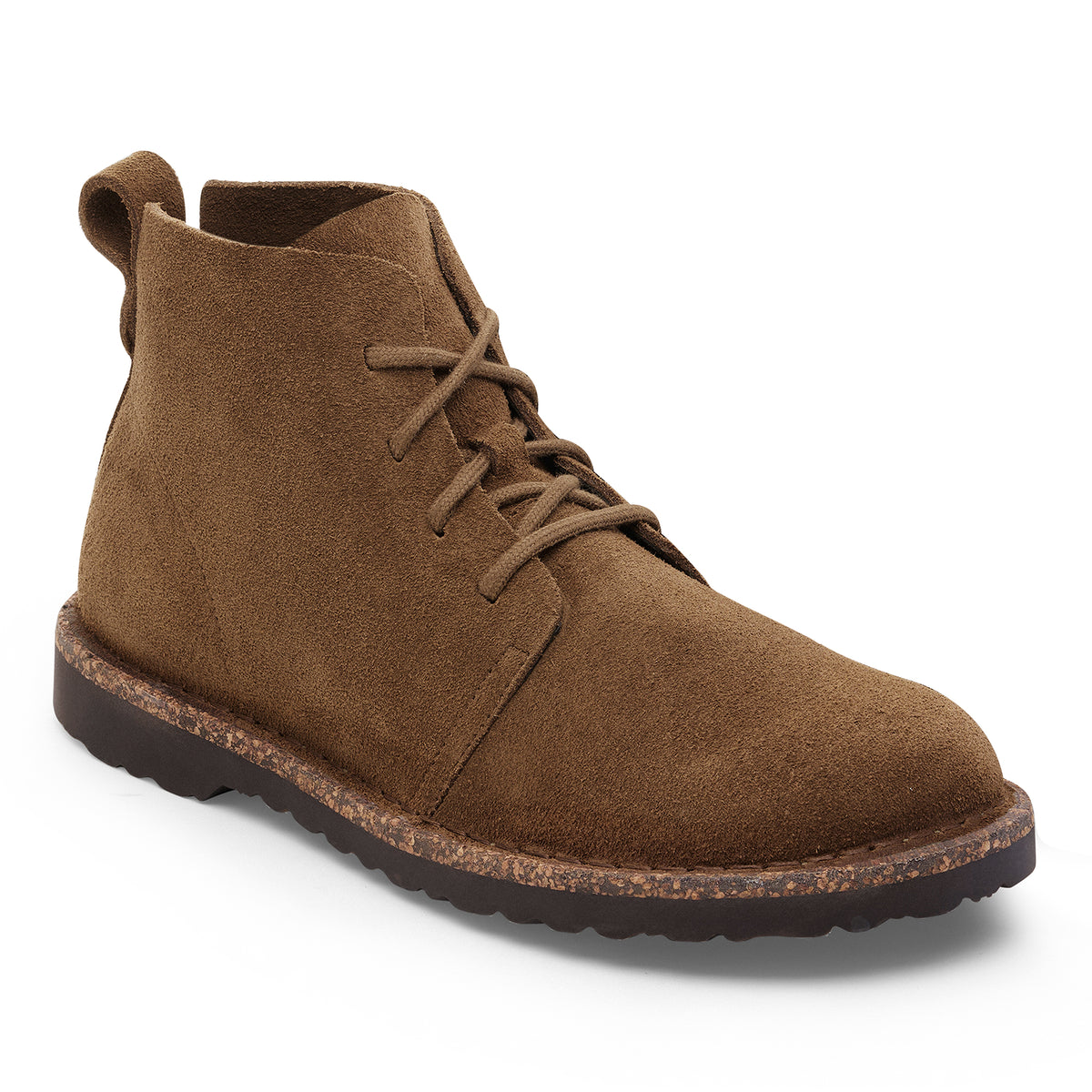 The boot features a casual, ankle-high silhouette with a rounded toe, structured heel, and relaxed lace-up front. Its streamlined shape combines the classic look of a chukka boot with a slightly rugged, laid-back feel.