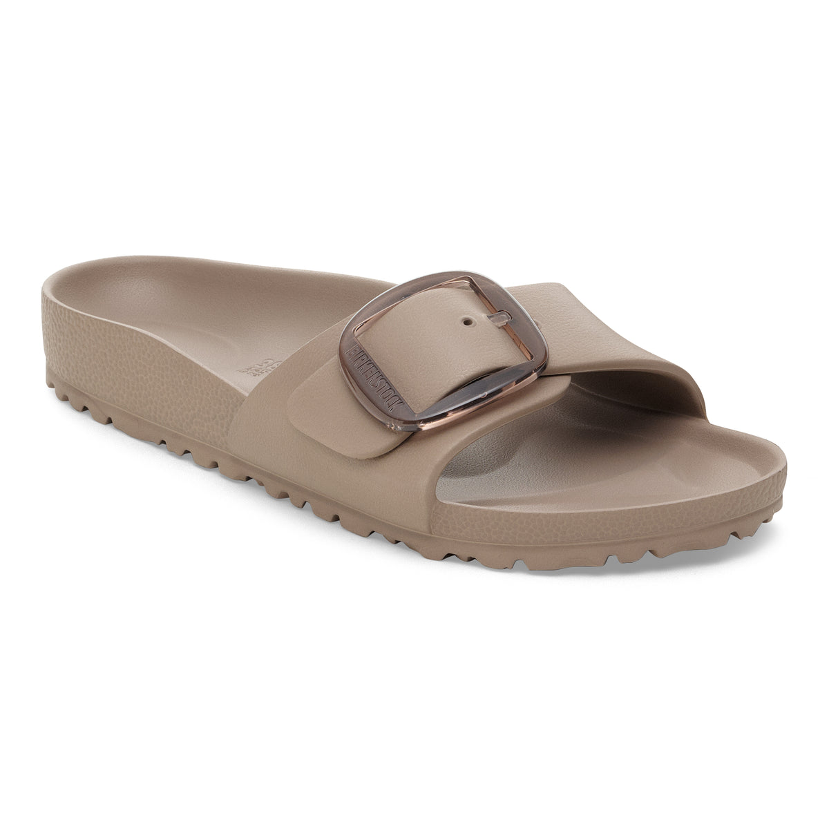 Beige sandal with a brown buckle on a white background