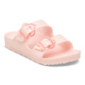 Pink sandal with teo straps a flower shaped buckle on each strap on a white background