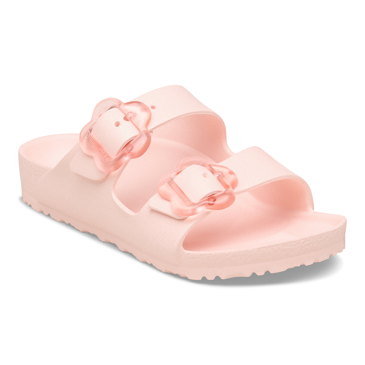 Pink sandal with teo straps a flower shaped buckle on each strap on a white background